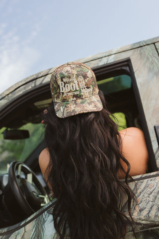 “We’ll Put A Boot In Your Ass” Camo Trucker Hat